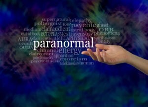Hand pointing at paranormal-themed word cloud.